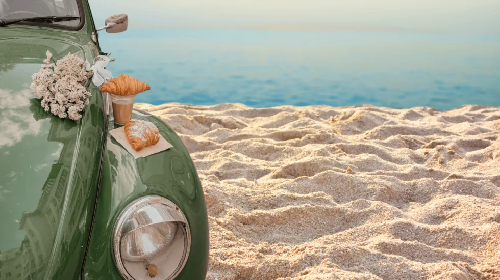 Car on the beach with flowers on it, aesthetic