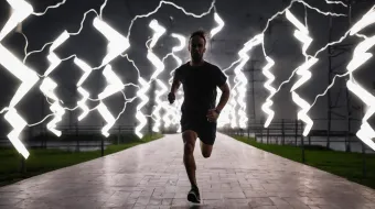 Man running with electricity behind him using sports gadgets