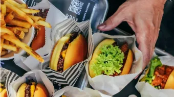 Hand reaching for a burger from SALT