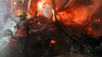 A rescuer works at the site of an Israeli attack on tents sheltering displaced people at a hospital in Deir el-Balah in central Gaza