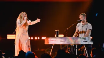 lyanna performs onstage with Chris Martin of Coldplay during the 2024 iHeartRadio Music Festival